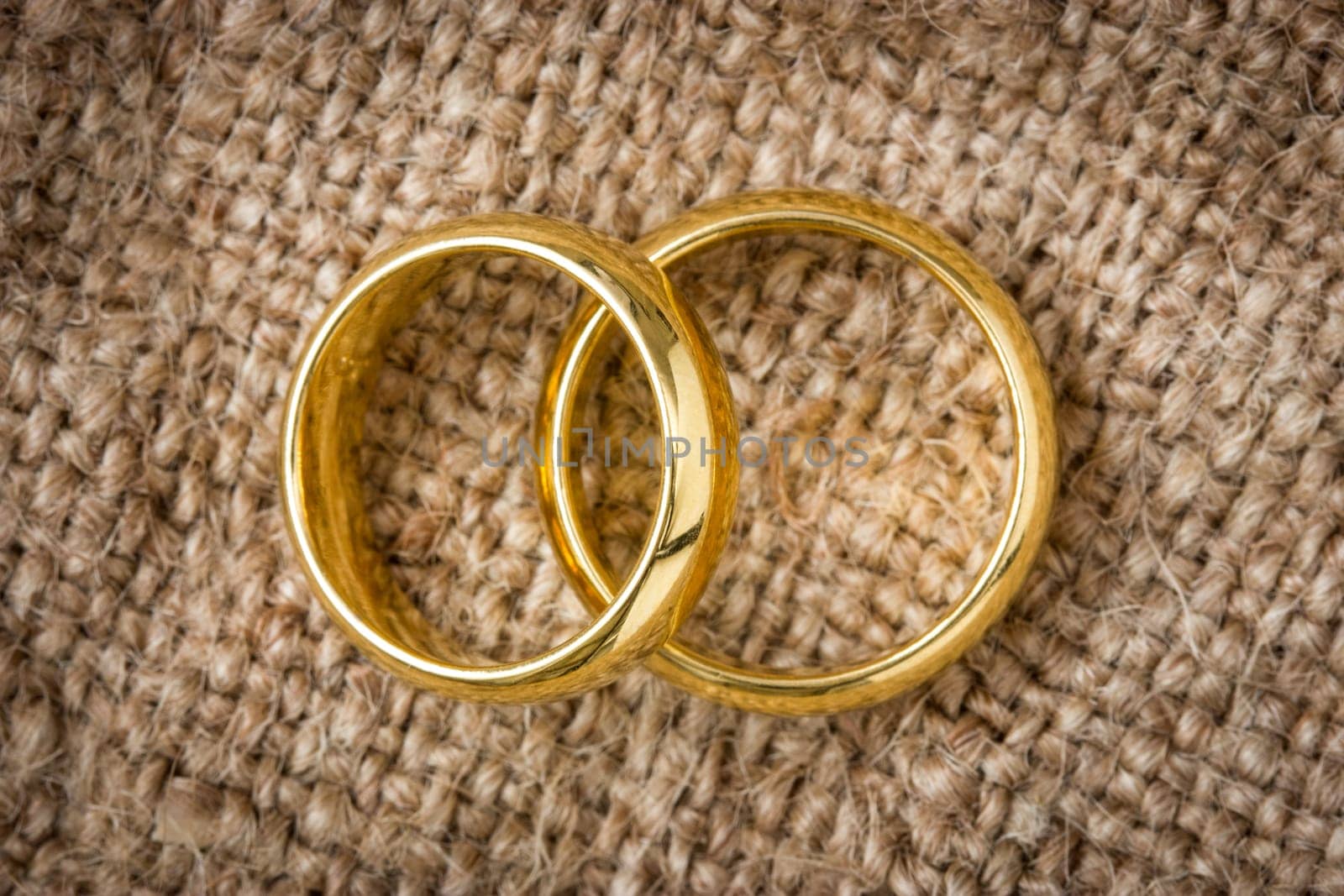 Two golden  rings on the burlap background
