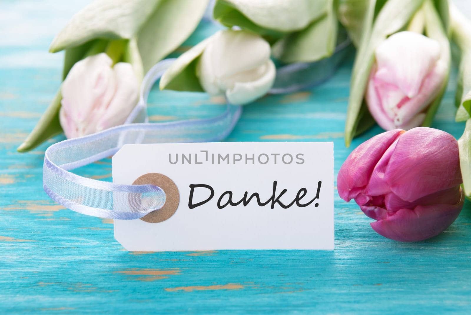 Banner with the German Word Danke which means Thanks on turquise Wood