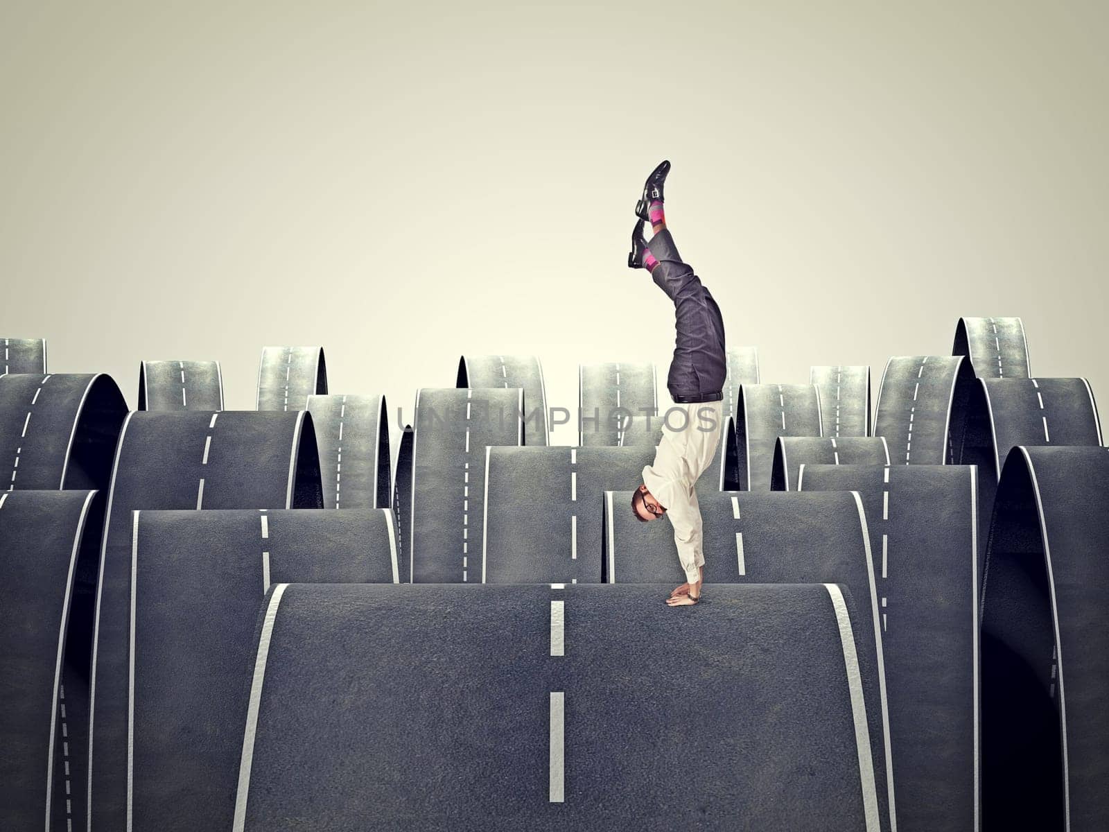 man balanced on his hands and abstract road background