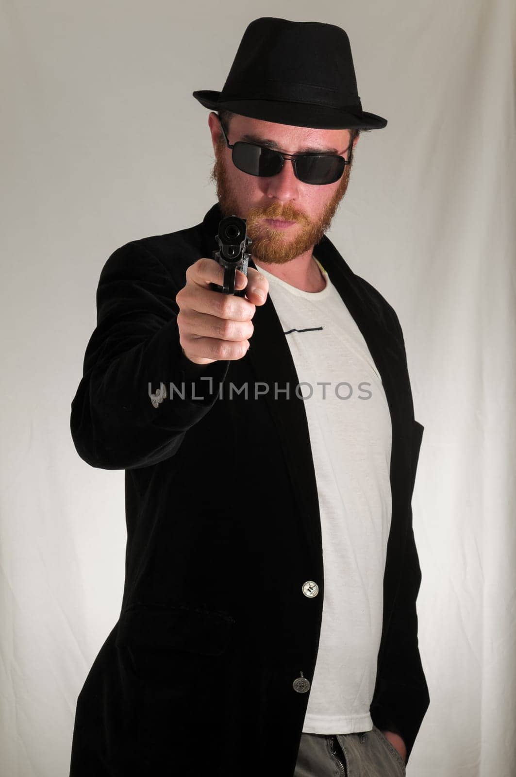 Black Dressed Young Man Holding a Pistol Gun