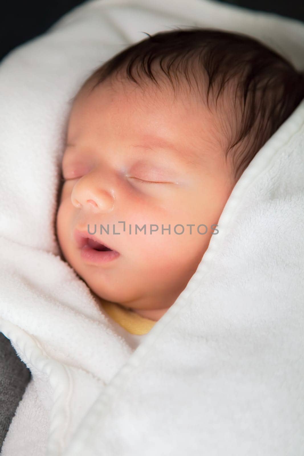 Newborn baby boy sleeping peaceful at home.