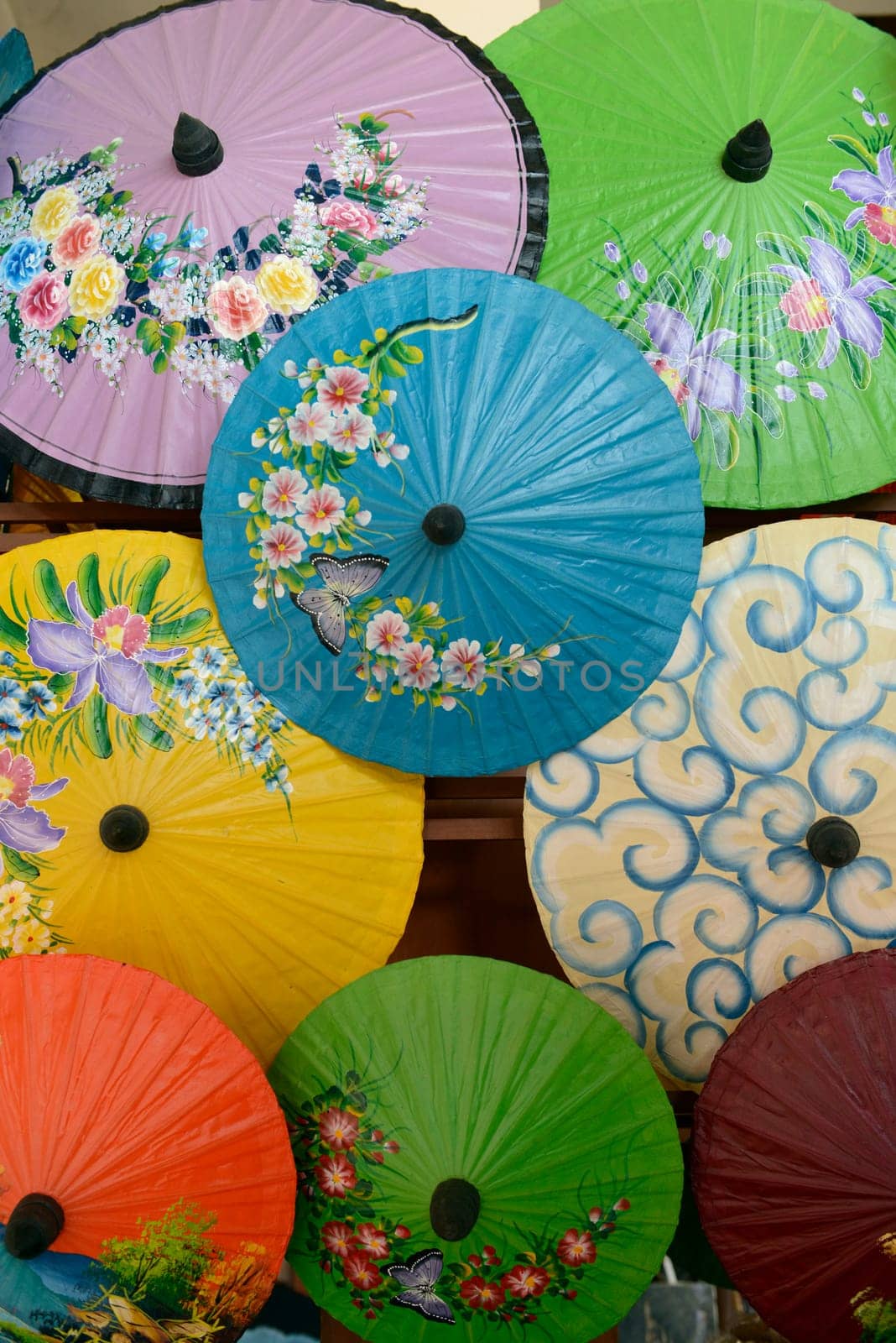 Traditionall umbrellas and faechers from Paier are produced in a paper screen factory in Chiang Mai in the north of Thailand in South East Asia.