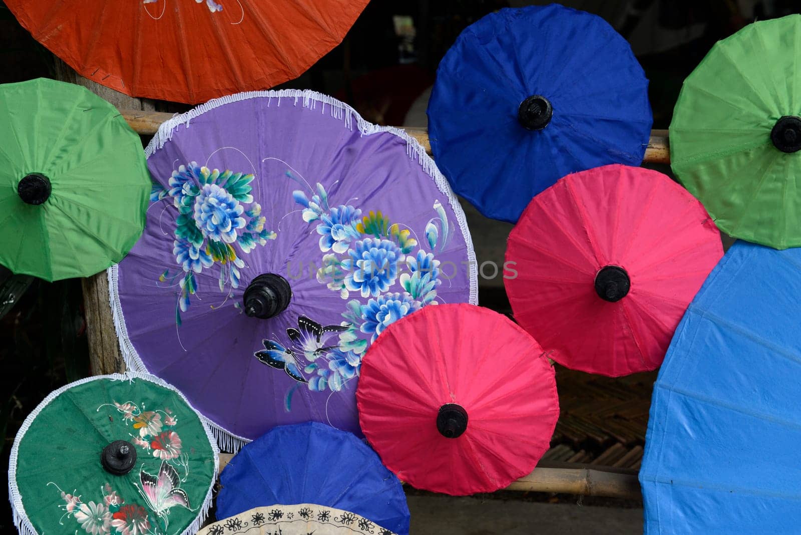 Traditionall umbrellas and faechers from Paier are produced in a paper screen factory in Chiang Mai in the north of Thailand in South East Asia.
