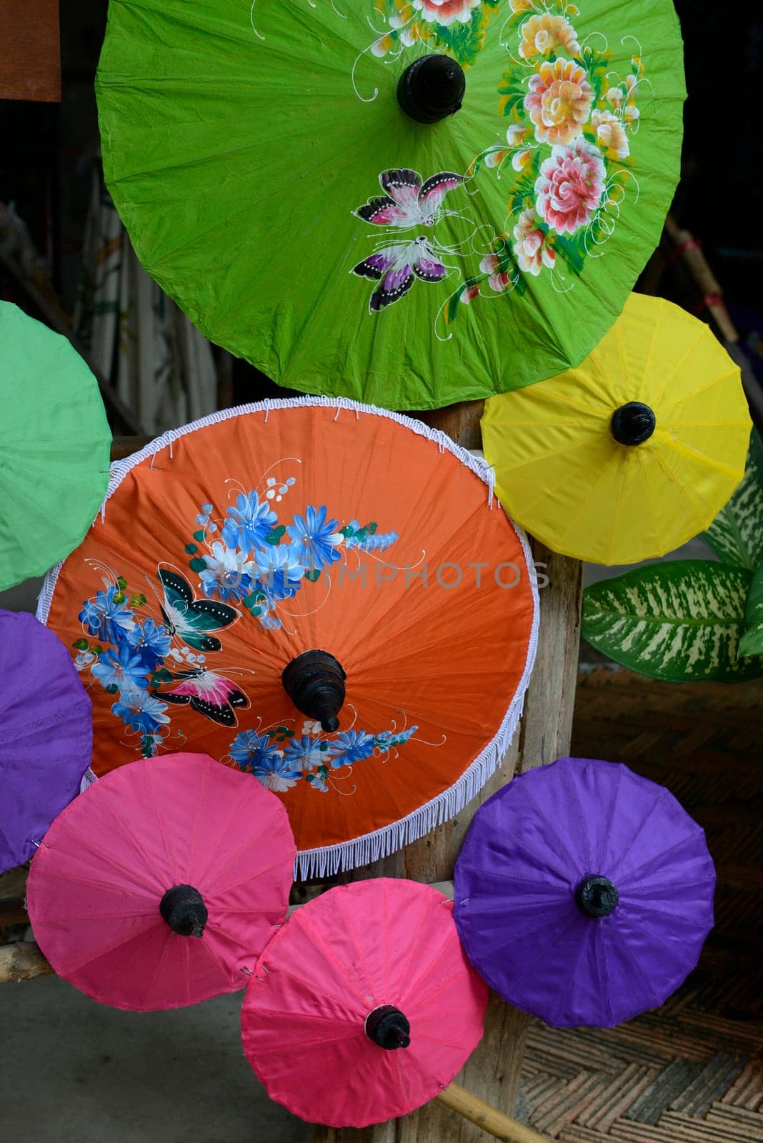 Traditionall umbrellas and faechers from Paier are produced in a paper screen factory in Chiang Mai in the north of Thailand in South East Asia.