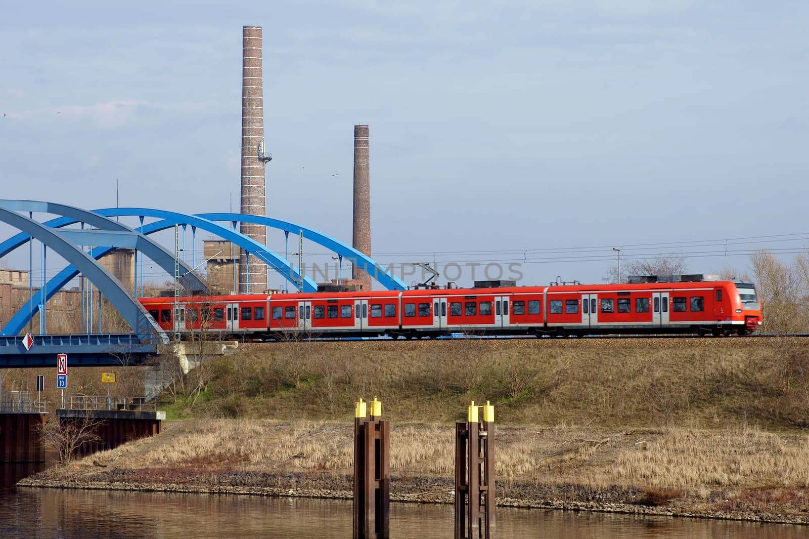 The photograph of a railway bridge (Wittenberge,Brandenburg) with a passing train.