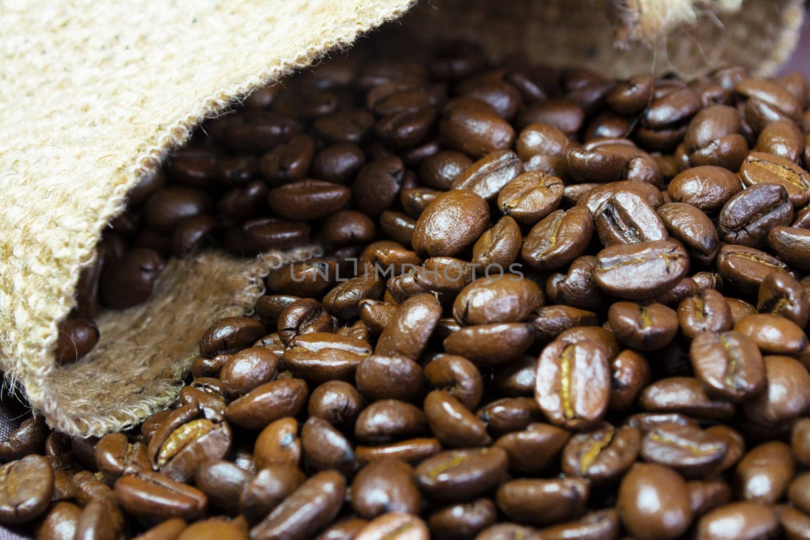 Detail of coffee beans outside his jute bag