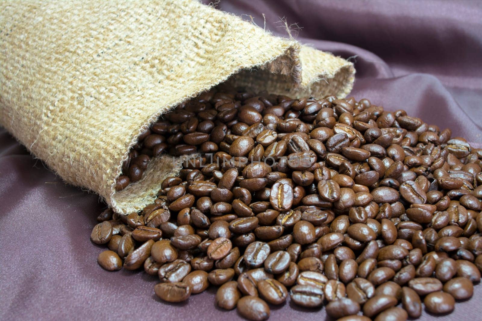 Detail of coffee beans and jute bag with background