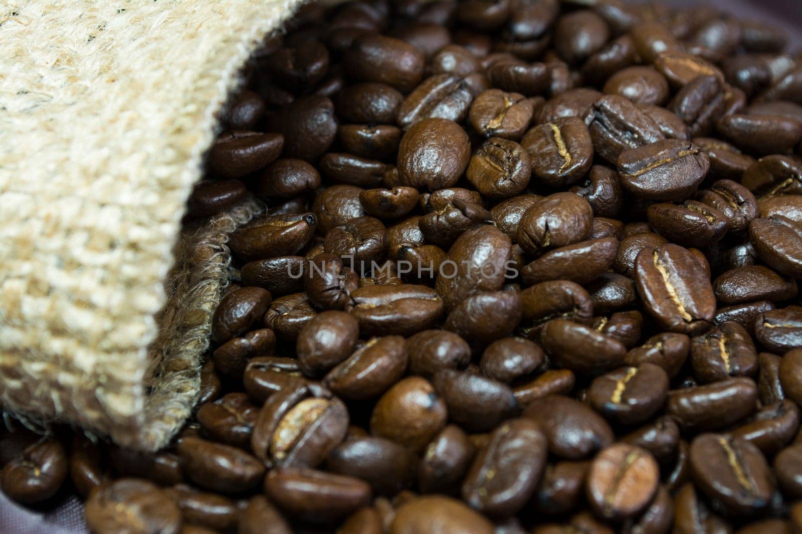 Detail of coffee beans outside his jute bag
