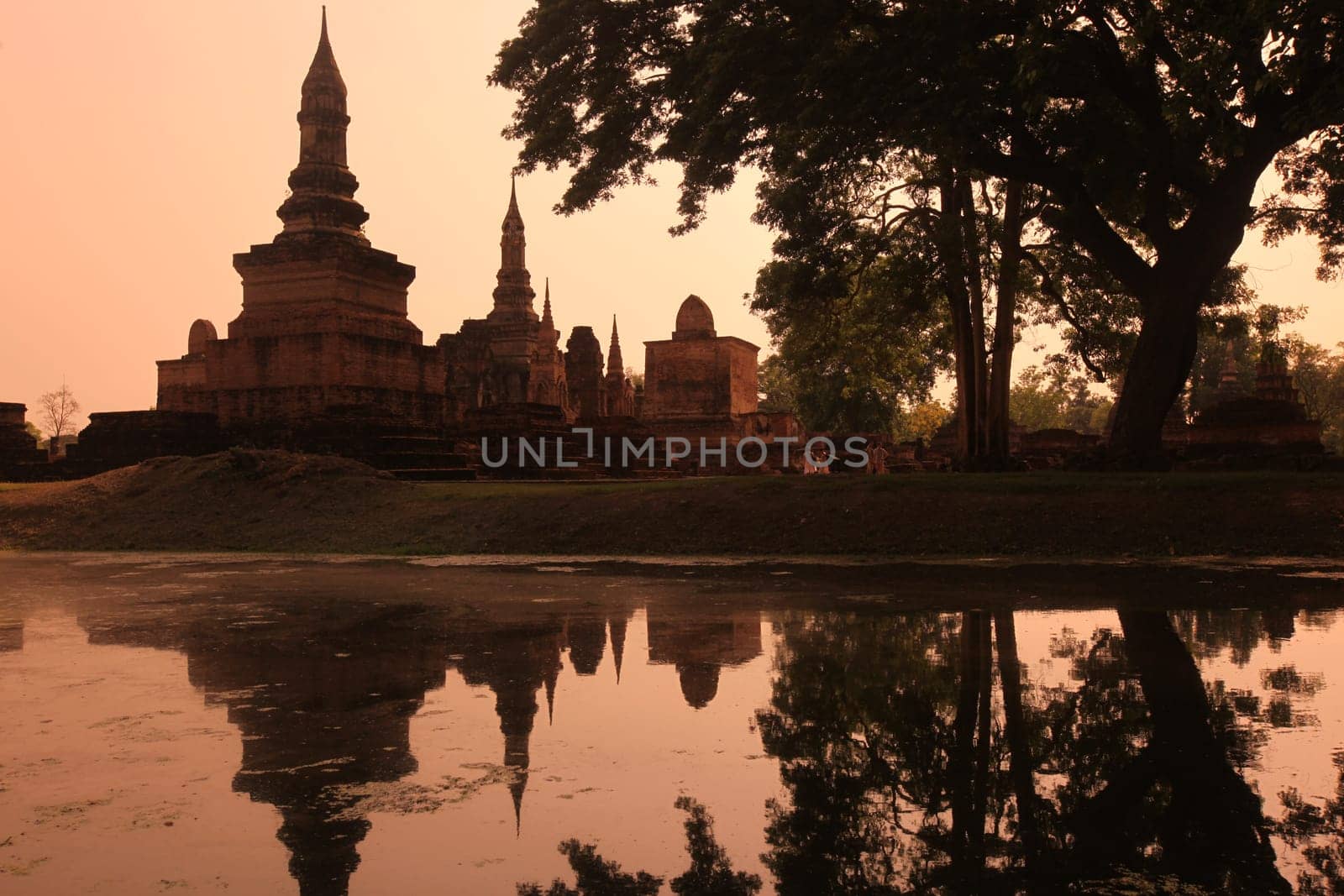 A chedi at the Wat Mahathat Temple in the temple complex of Alt-Sukhothai in Sukhothai province in northern Thailand in South East Asia.