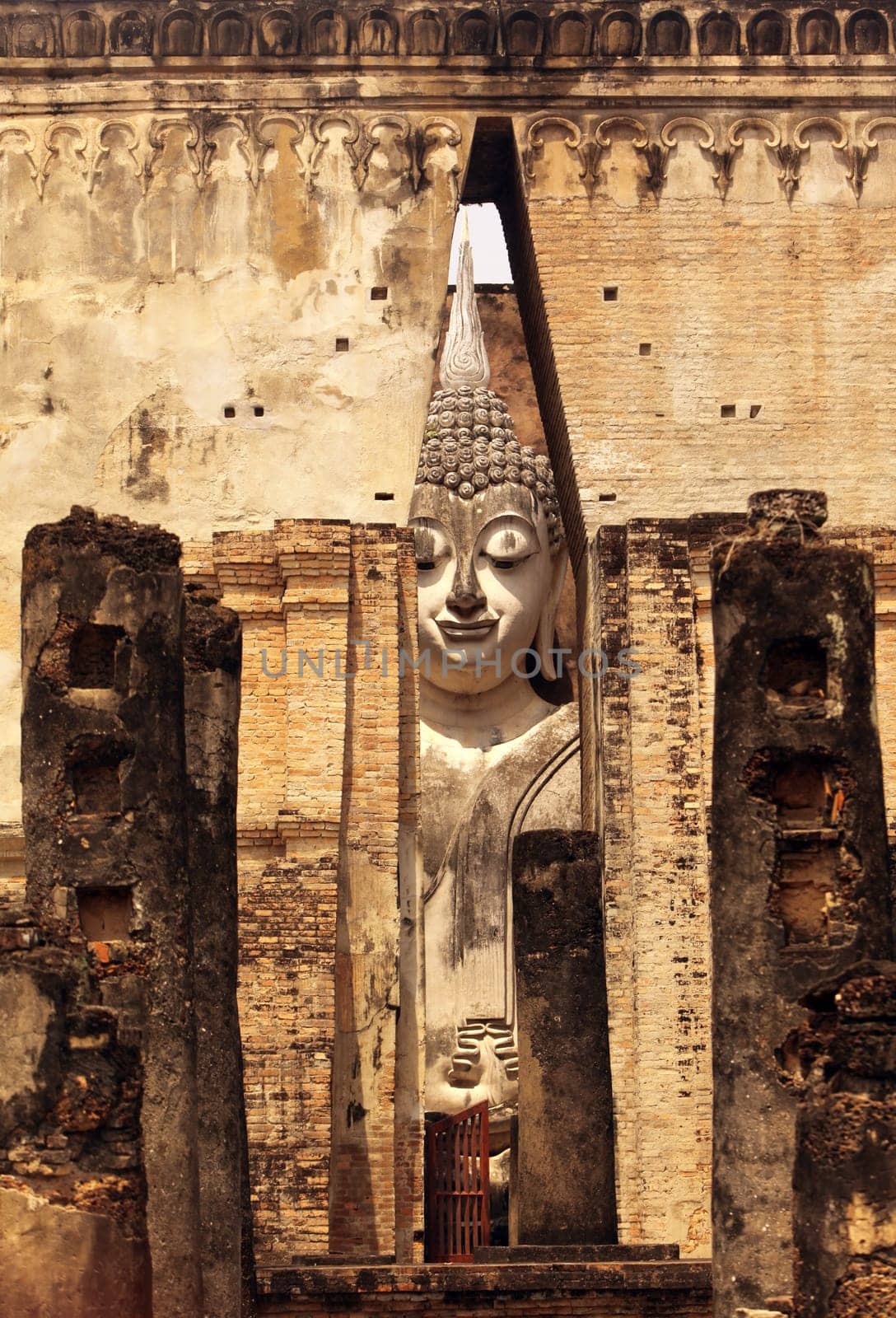 The Buddha figure in the Wat Si Chum temple in the temple complex of Alt-Sukhothai in the province of Sukhothai in northern Thailand in South East Asia.