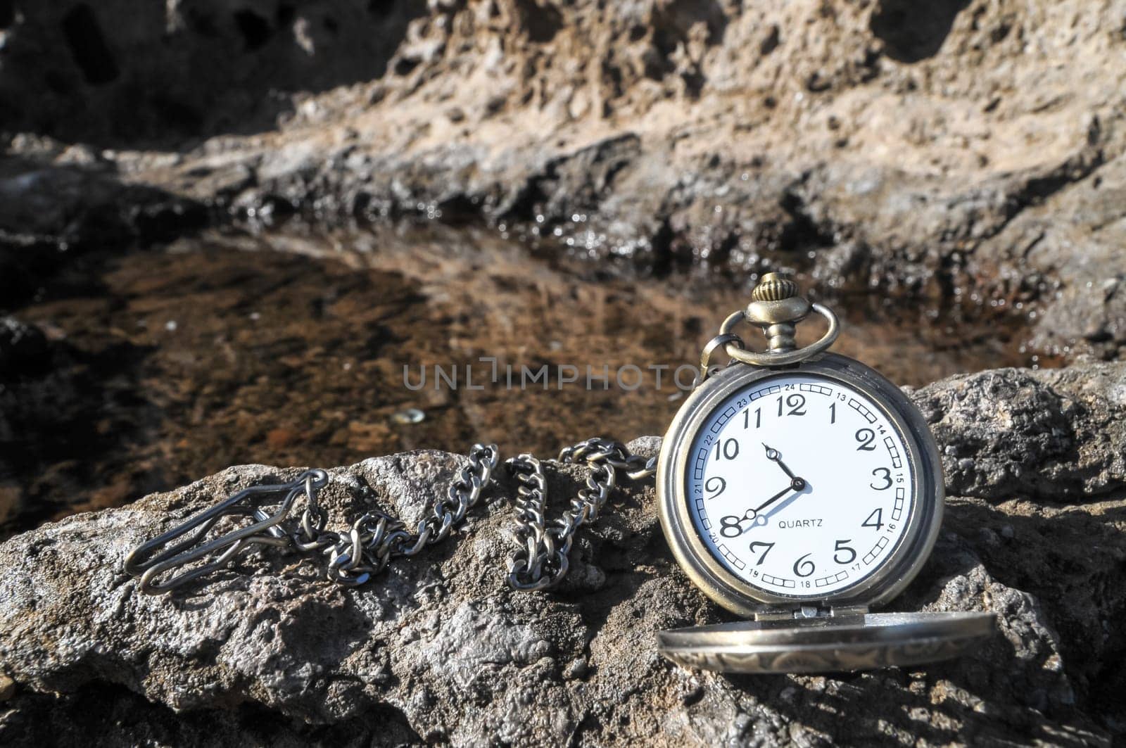 Time Concept Classic Vintage Pocket Clock on the Volcanic Rocks
