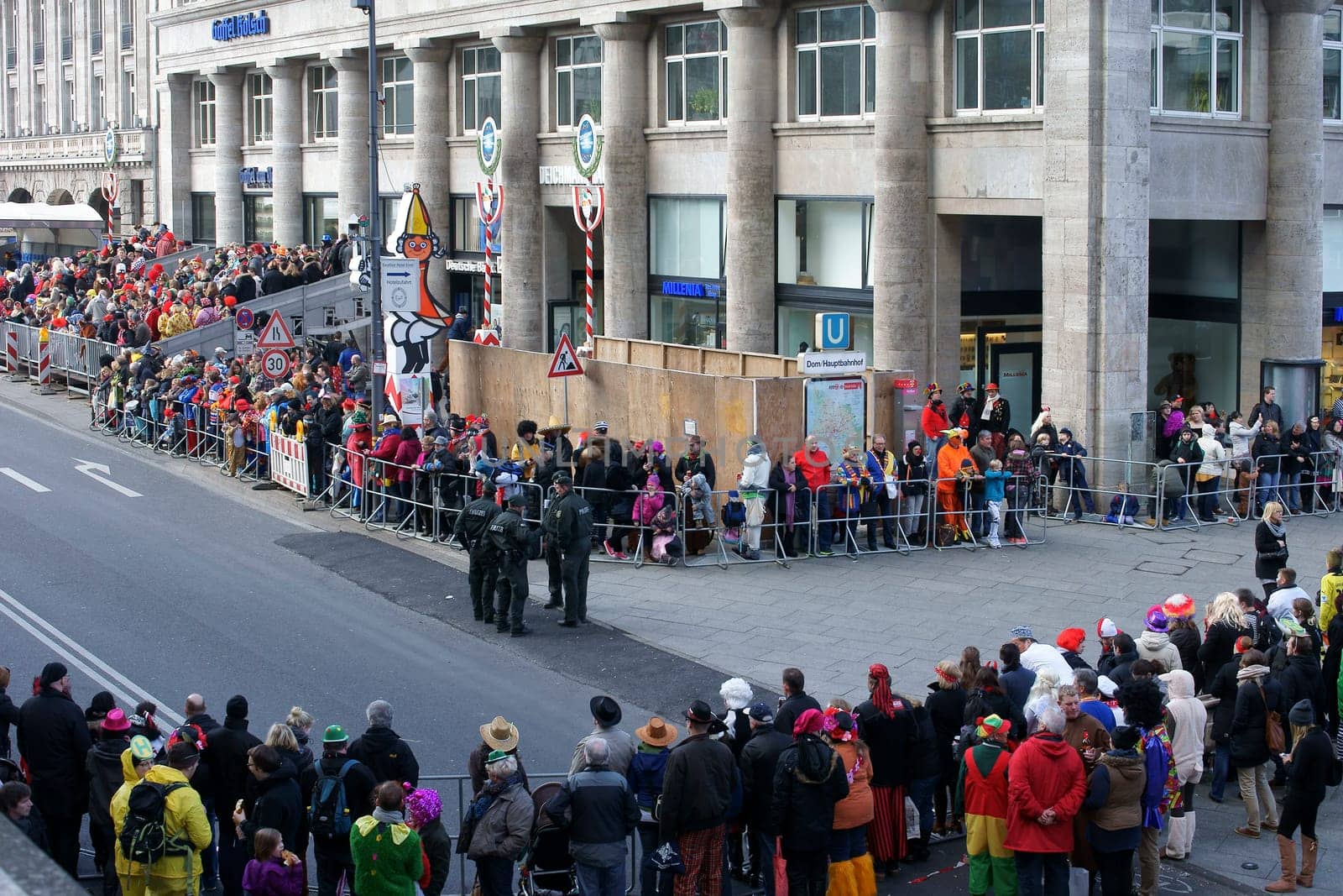 Cologne,Germany – March 02,2014: Colourfully dressed people wearing masks and costumes await the carnival procession on March 2,2014 in Cologne.