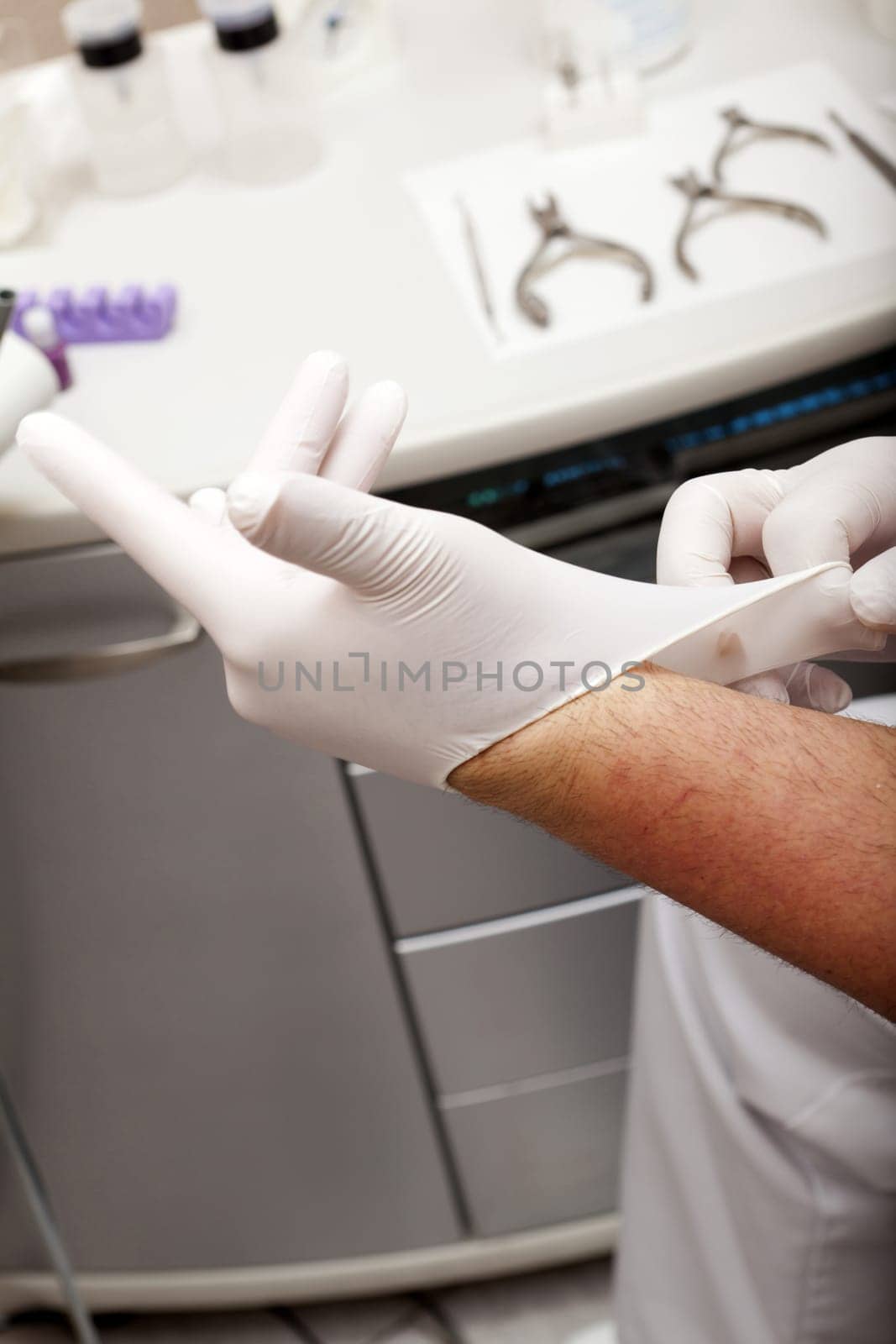 Foot care worker puts on gloves