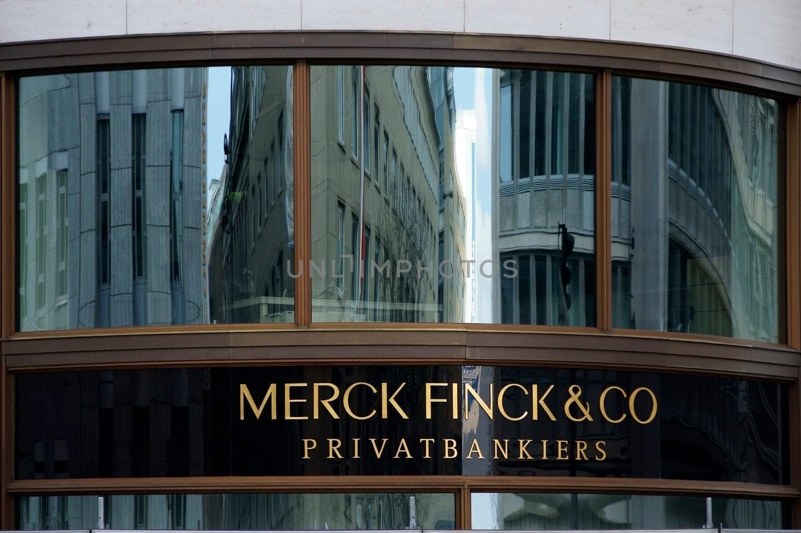 Cologne,Germany - March 02,2014: The entrance sign of Merck Fink and Co Bank with reflections in the window on March 2,2014 in Cologne.