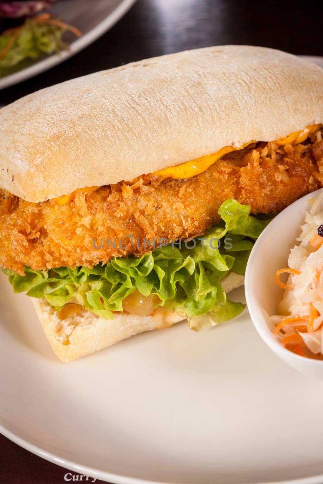 Chickenburger with chicken meat and salad as a close-up on a plate