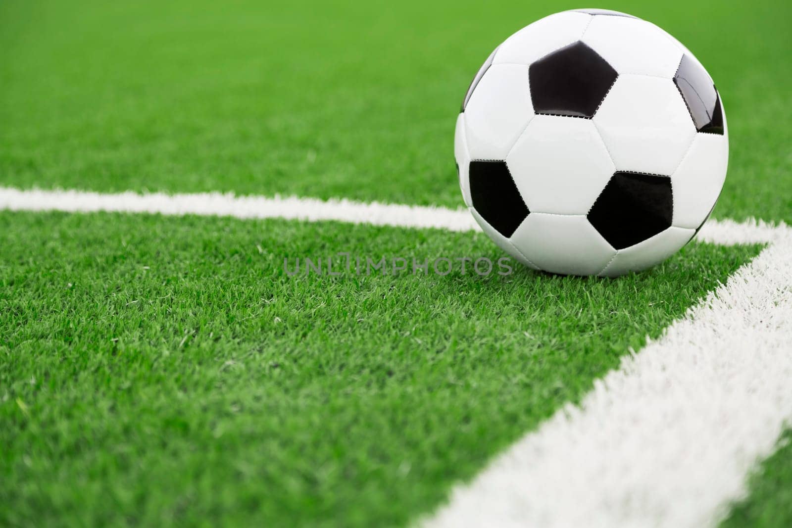 Traditional soccer ball on soccer field