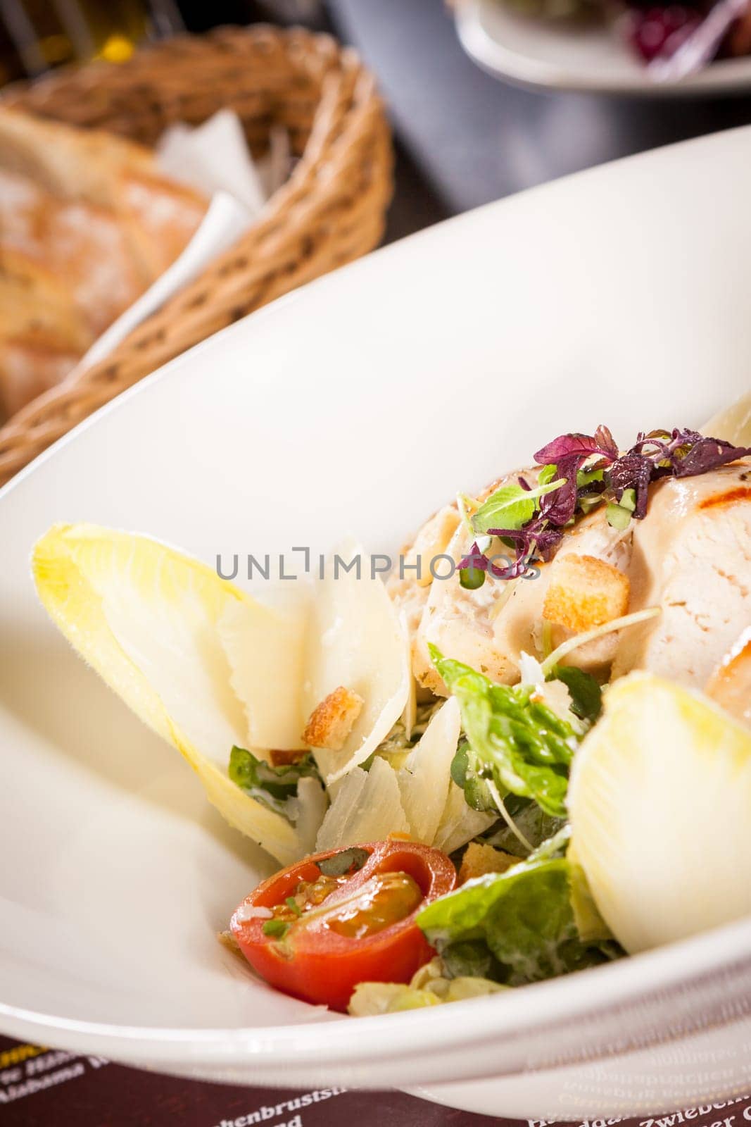 Fresh delicious caesarsalat with grilled chicken bust parmesan splinters and croutons