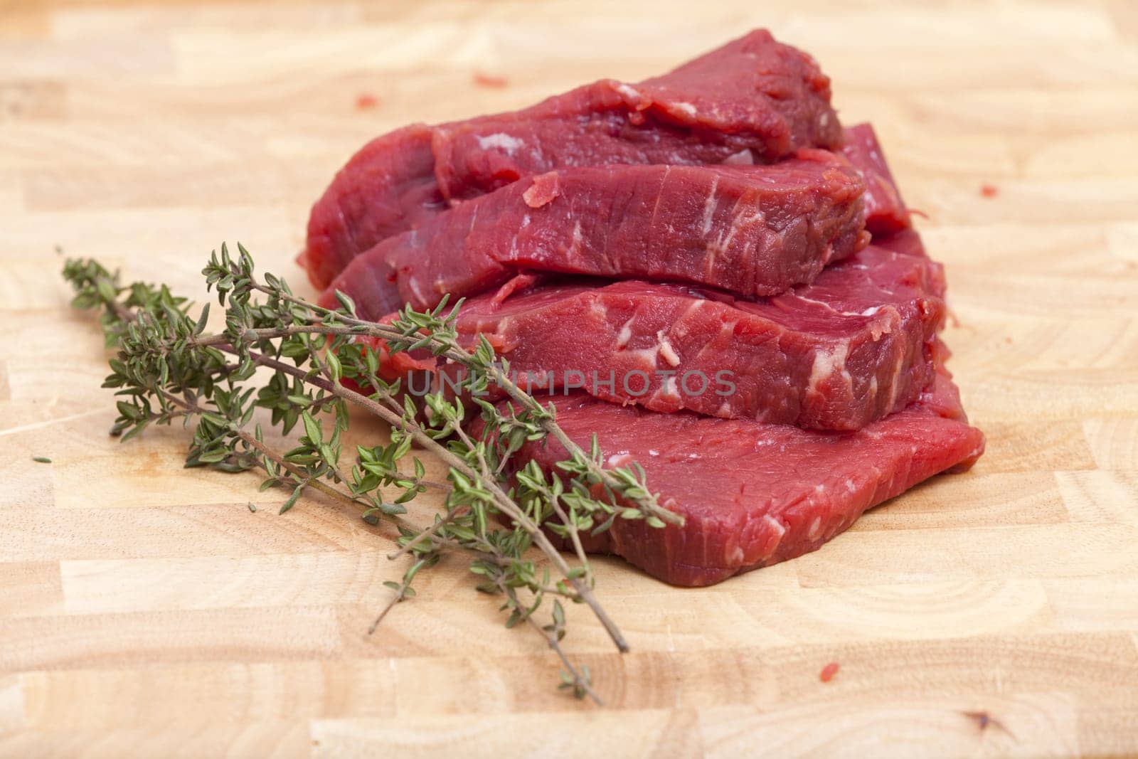 Four slices of beef fillet with thyme branch