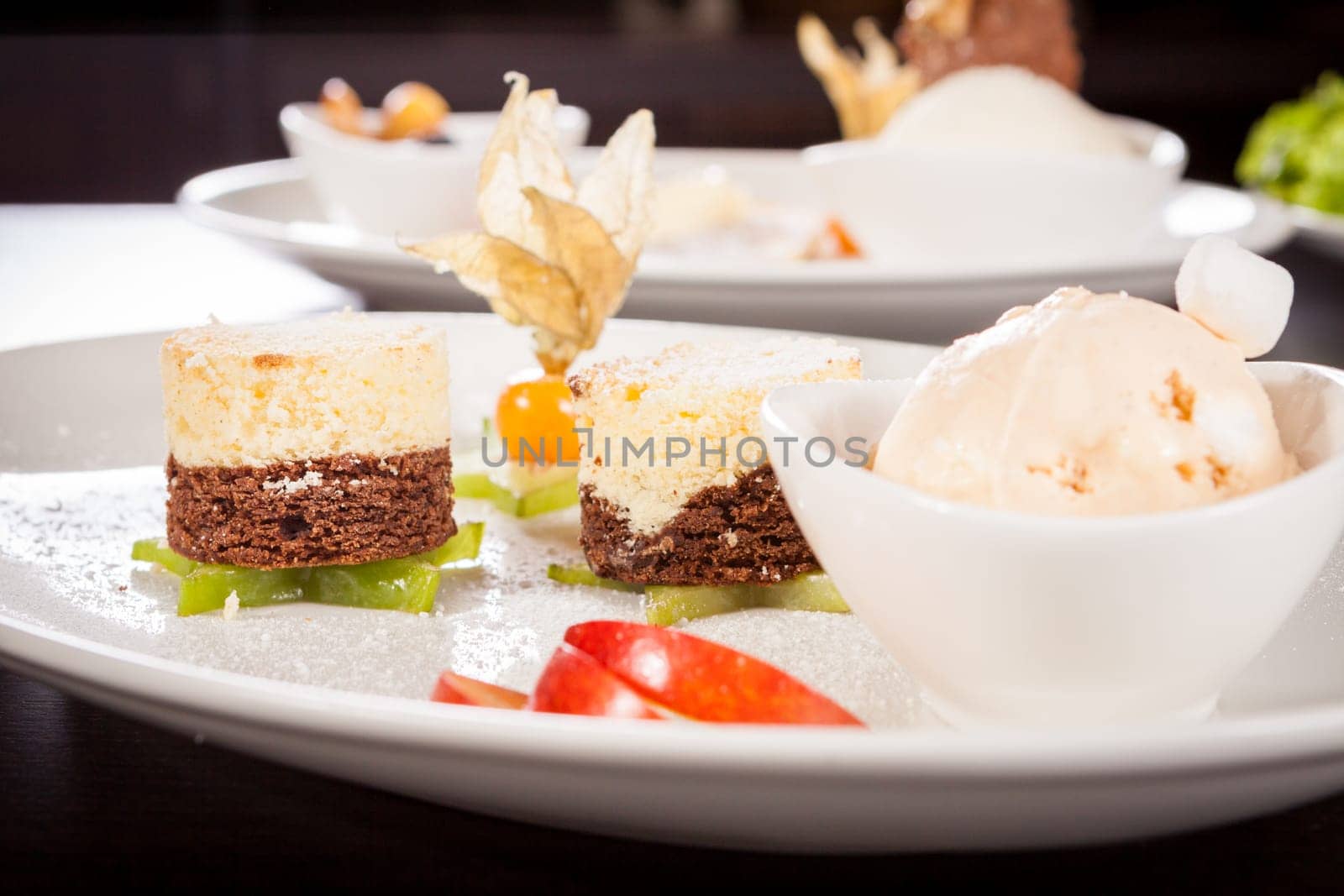 Brownie chocolate brownie with ice cream and plums prepared on a plate