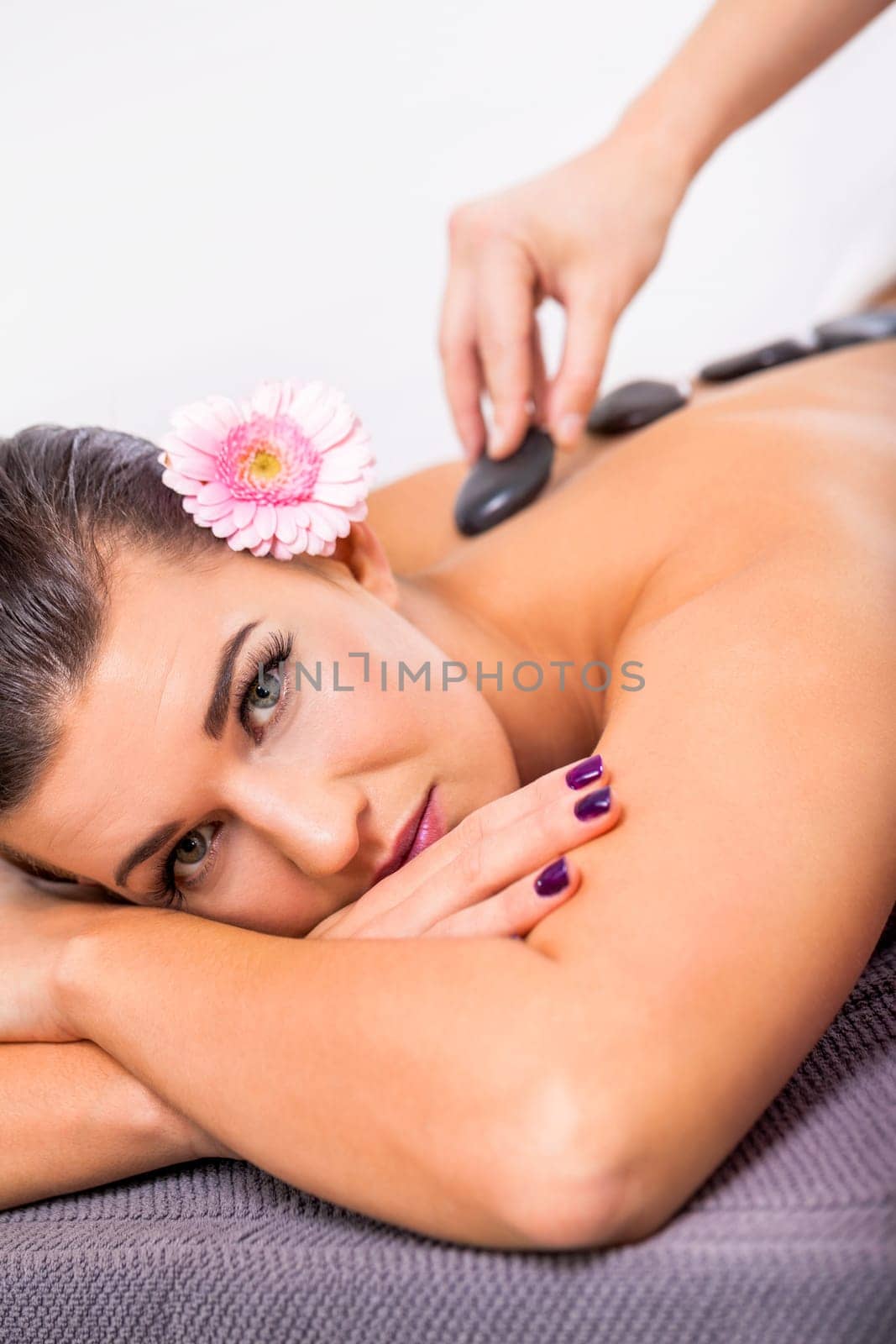 young woman relaxes during a back massage at salon wellness spa health therapy