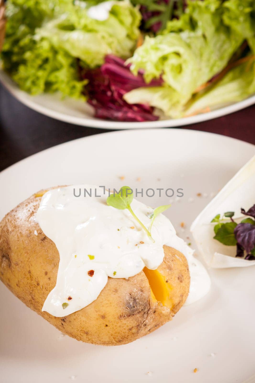 fresh foilpotato from the oven with herb quark sour cream and fresh herbs