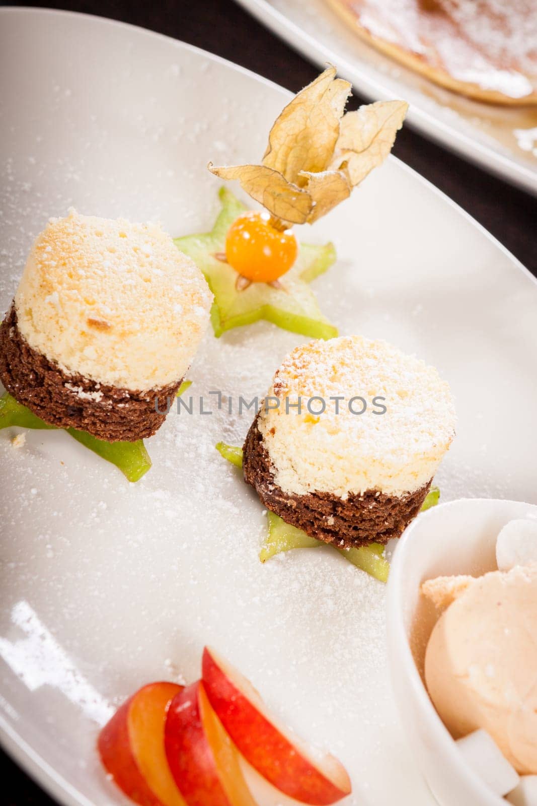 Brownie chocolate brownie with ice cream and plums prepared on a plate