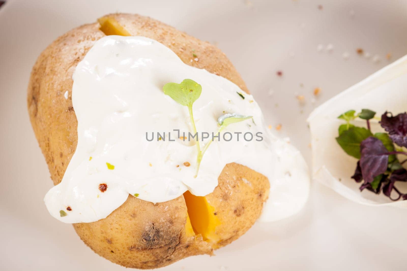 fresh foilpotato from the oven with herb quark sour cream and fresh herbs