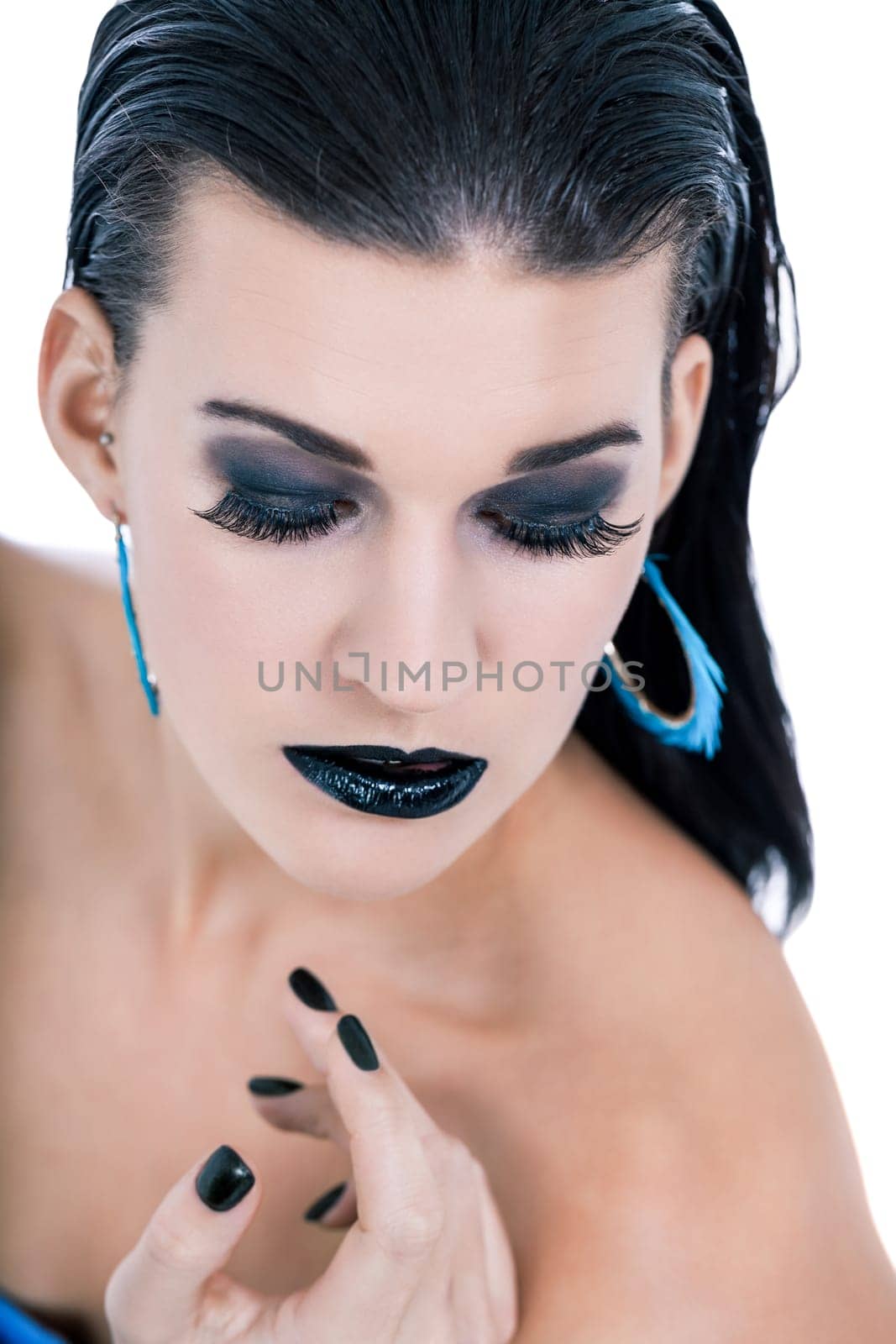 attractive young woman with black hair blue eyes and black makeup lips nail polish portrait