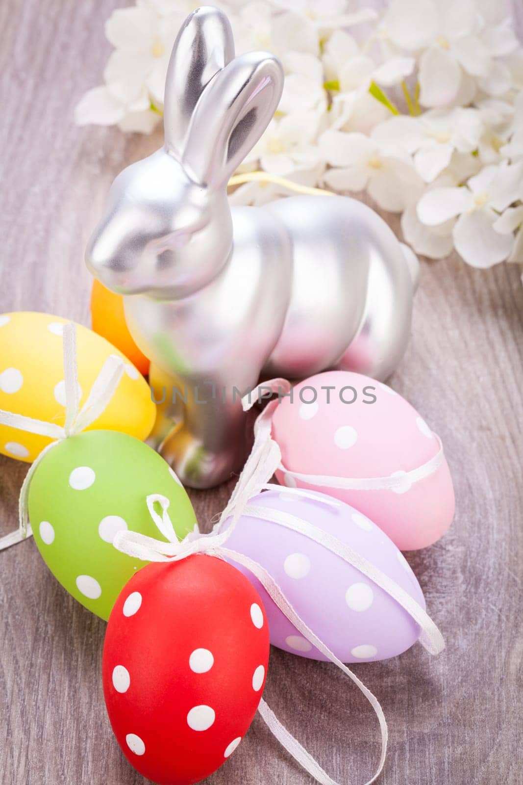 Colourful yellow and red Tulip with Easter eggs decorated at Easter with text space on green background