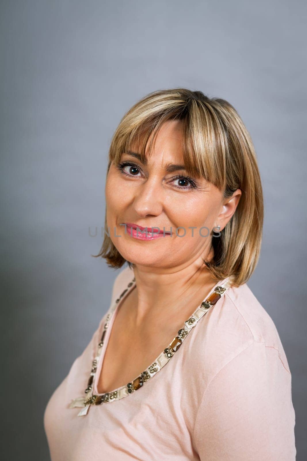 adult attractive woman in middle age portrait against gauem background