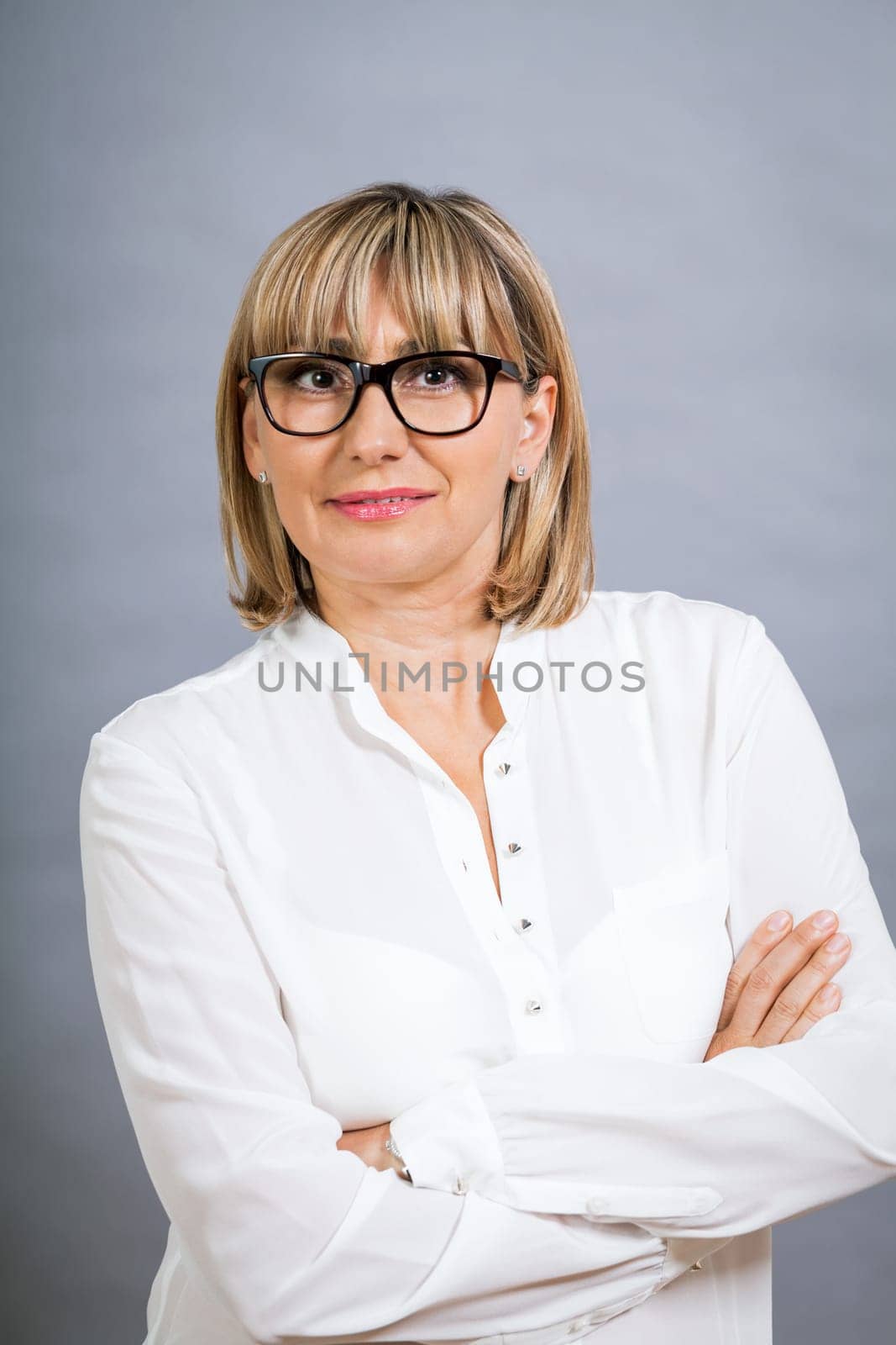 attractive adult woman in middle age with white blouse and brille