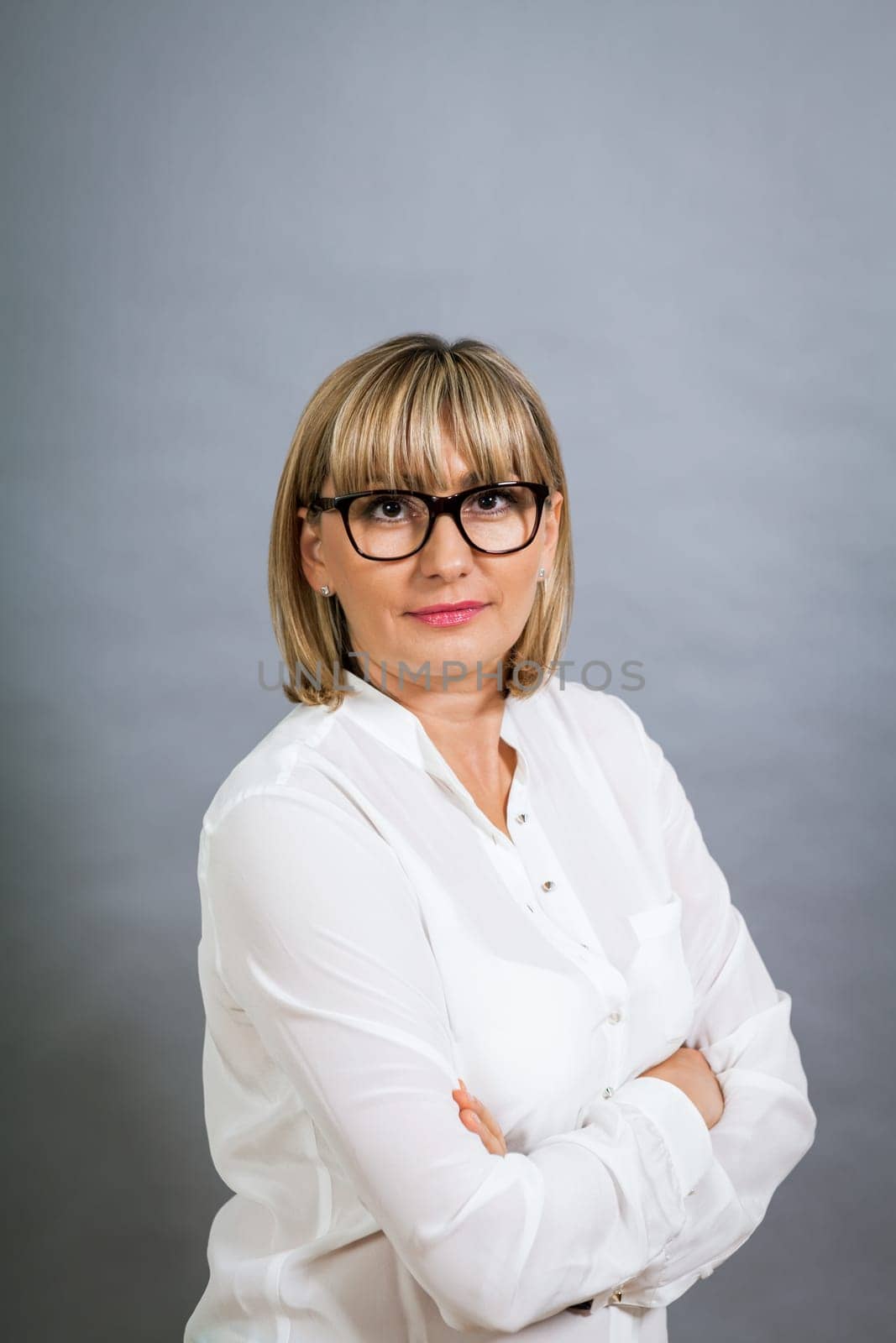 attractive adult woman in middle age with white blouse and brille