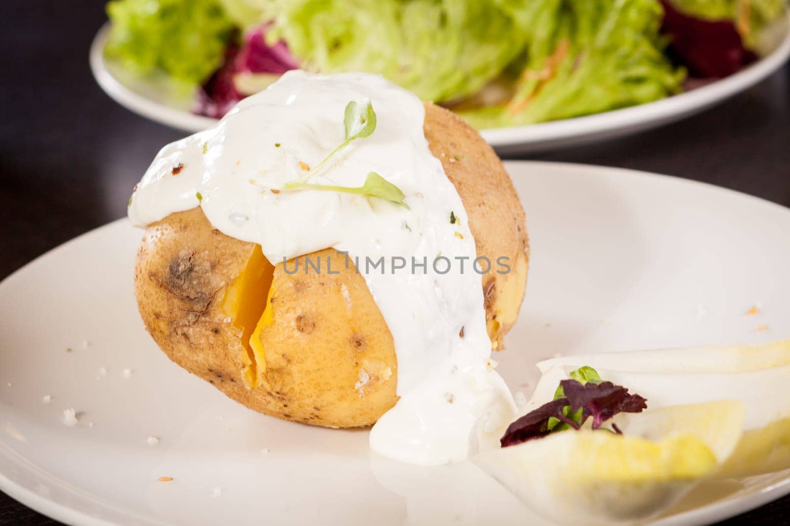 fresh foilpotato from the oven with herb quark sour cream and fresh herbs