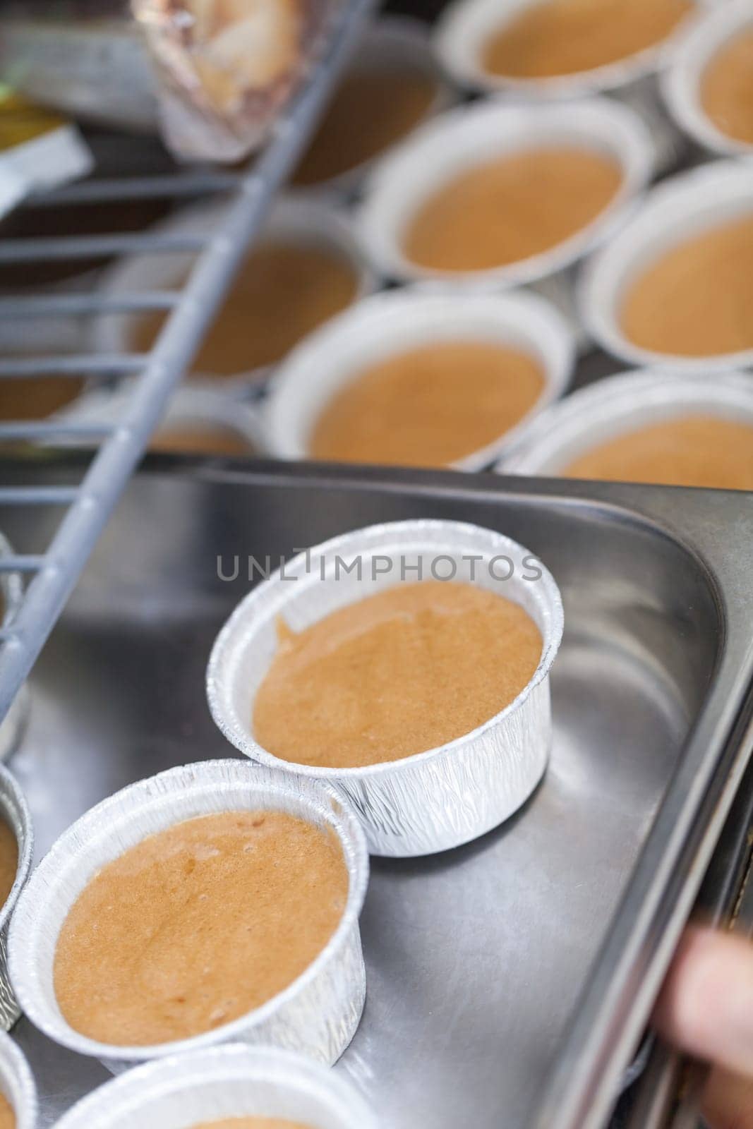 chef solves freshly baked tarts from the mould in the kitchen restaurant pastry shop