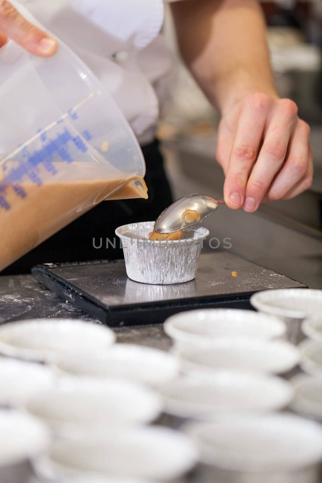 chef solves freshly baked tarts from the mould in the kitchen restaurant pastry shop