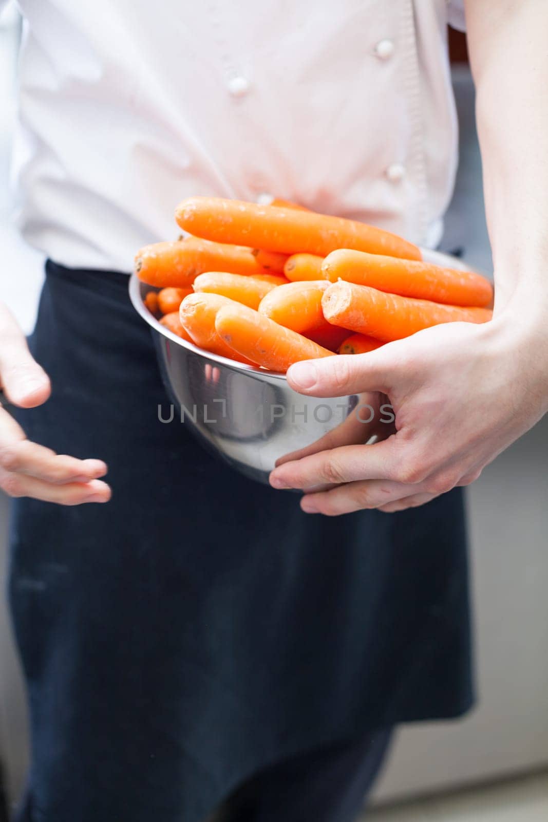 chef cuts fresh carrots in restaurant kitchen pre-beader ingredients eat food gastronomy work