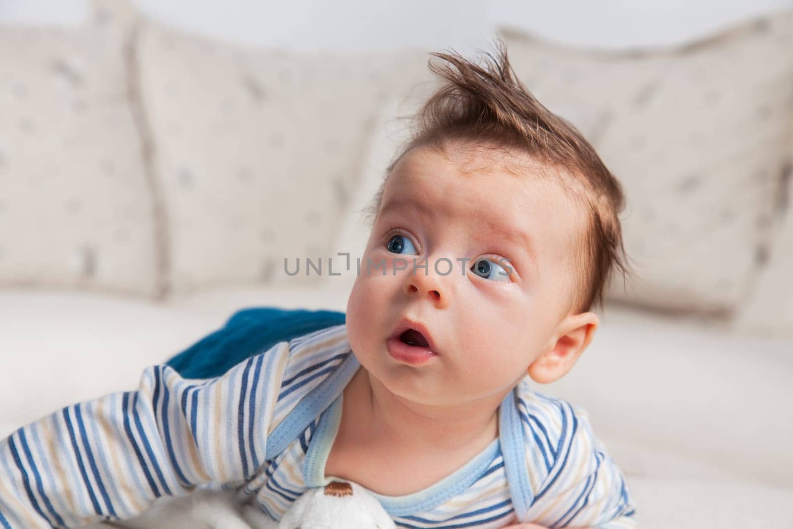 Studio portrait of a happy 3 months old baby boy at home.