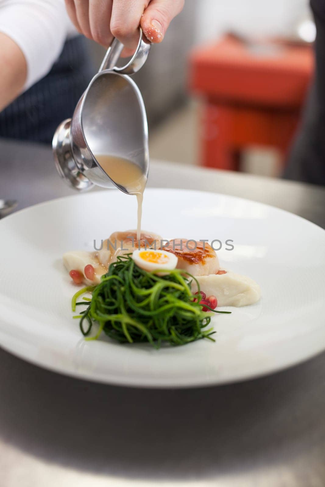 gourmet food with scallops and quail eggs and puree prepared with sauce