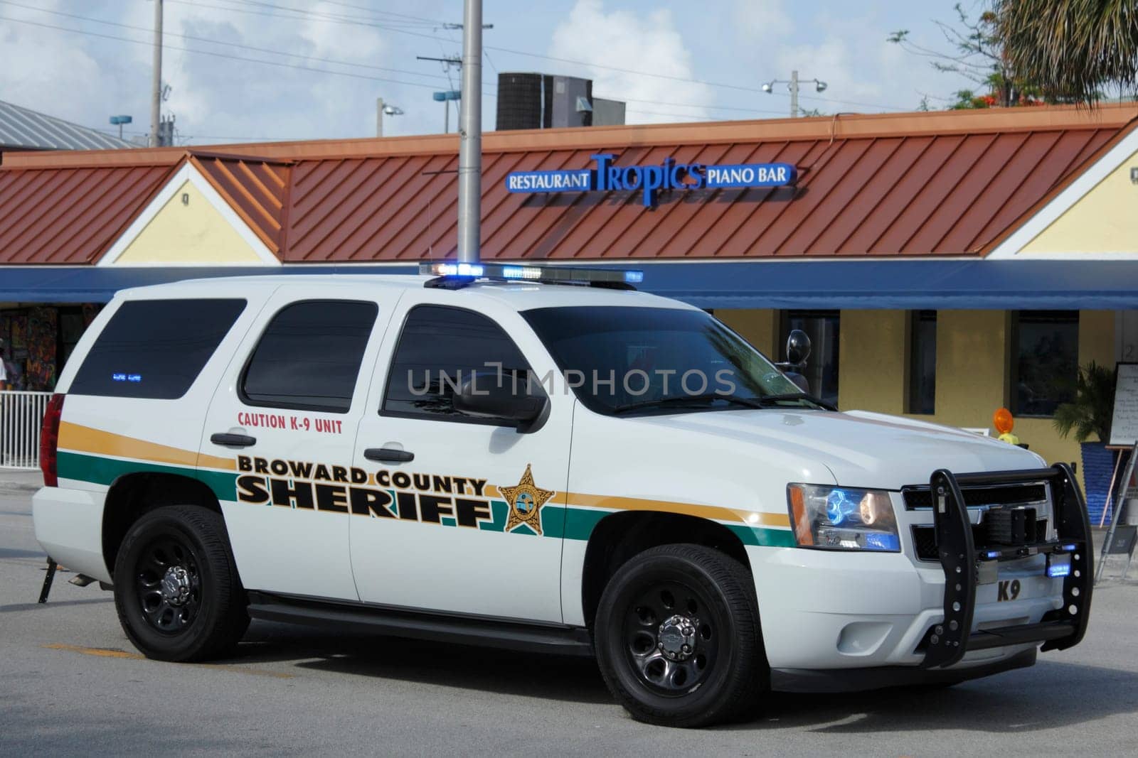 WILTON MANORS, FLORIDA - JUNE 23, 2013: Large white Broward County Sheriff K-9 truck with its lights on parked at entrance to second day of Stonewall Summer Pride on Wilton Drive at NE 20th Street.