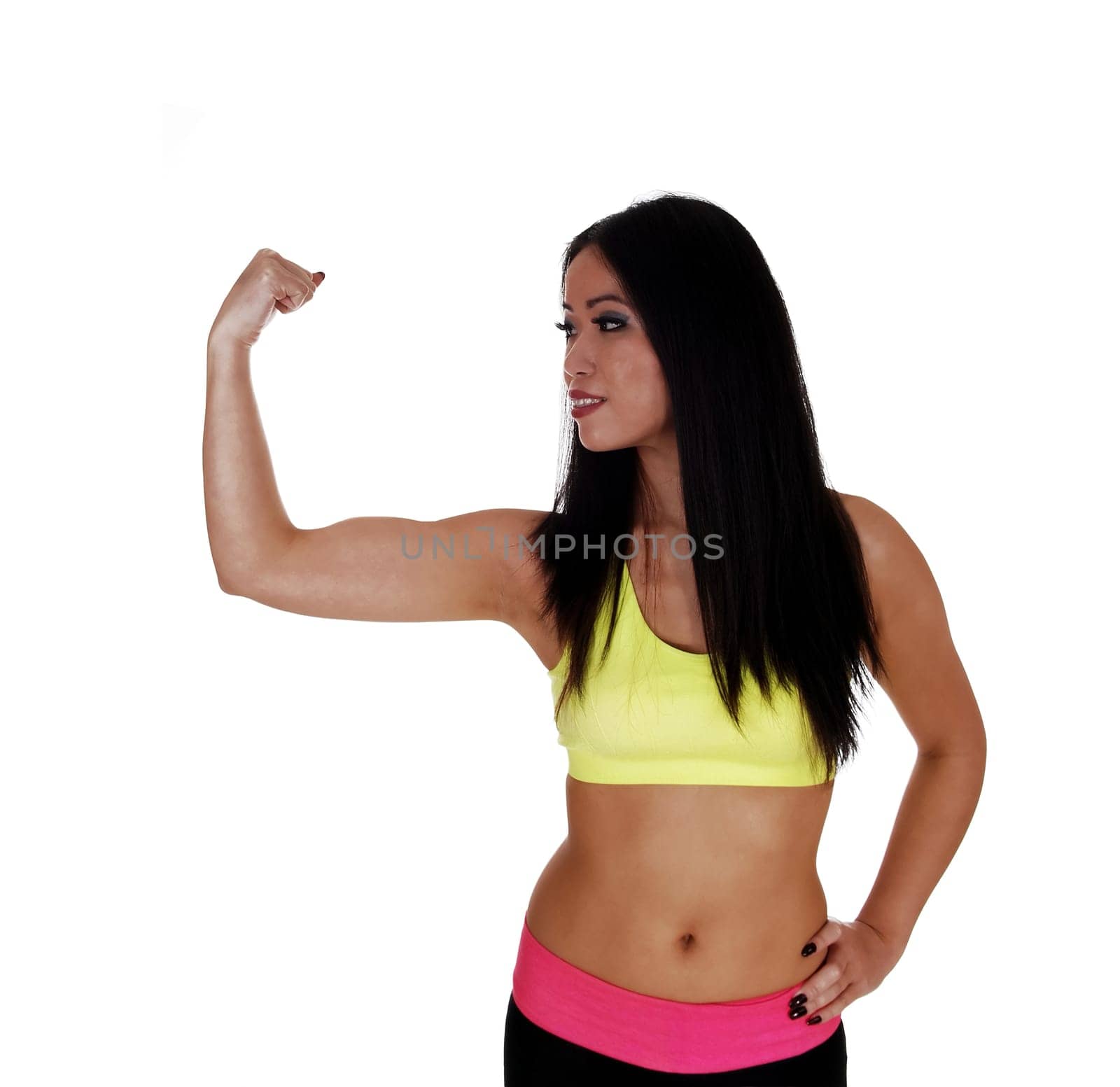 A smiling young Chinese woman in exercise outfit showing off her biceps.with her long black hair for white background..