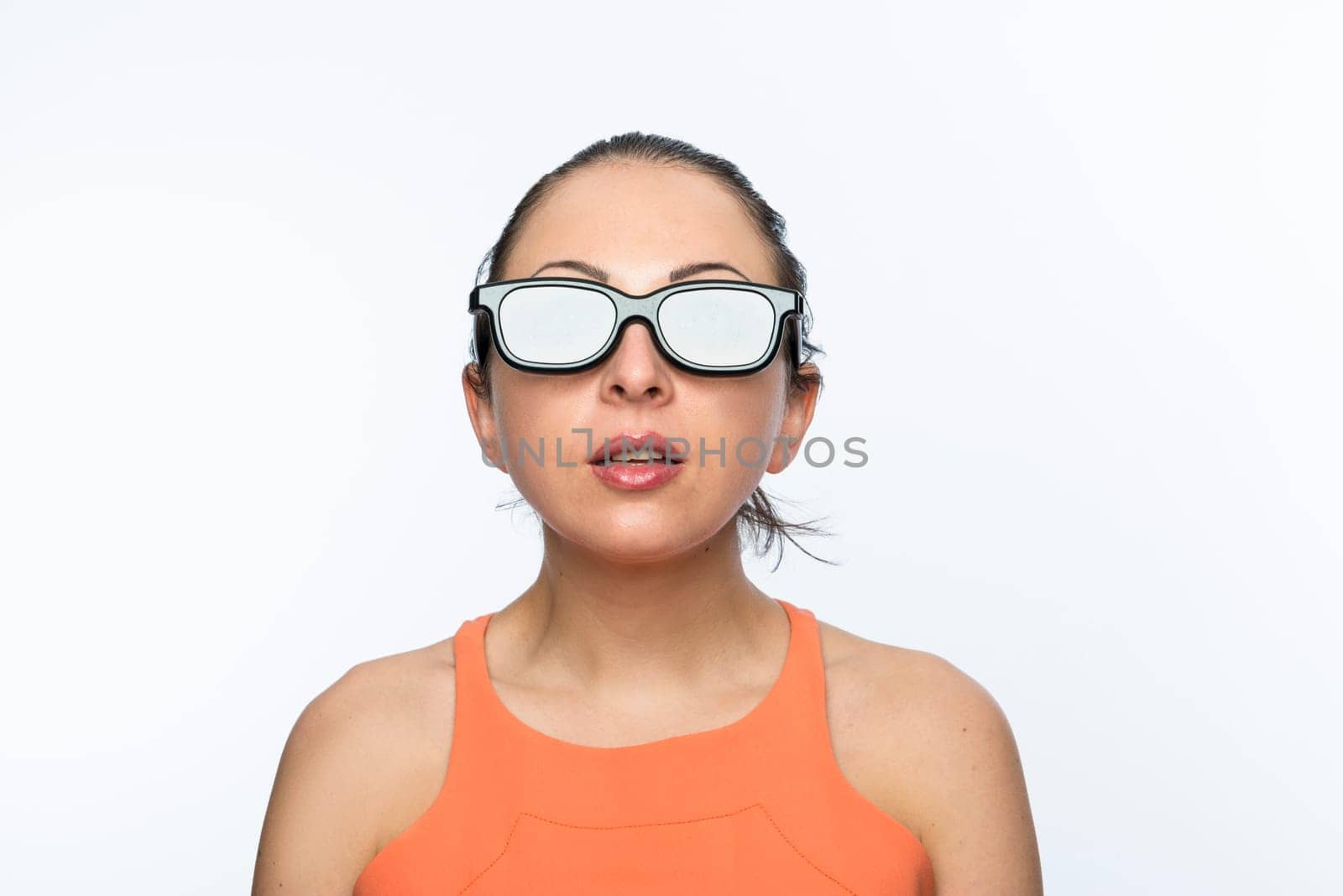 Portrait of beautiful caucasian woman wearing large 3D cinema glasses looking enthralled