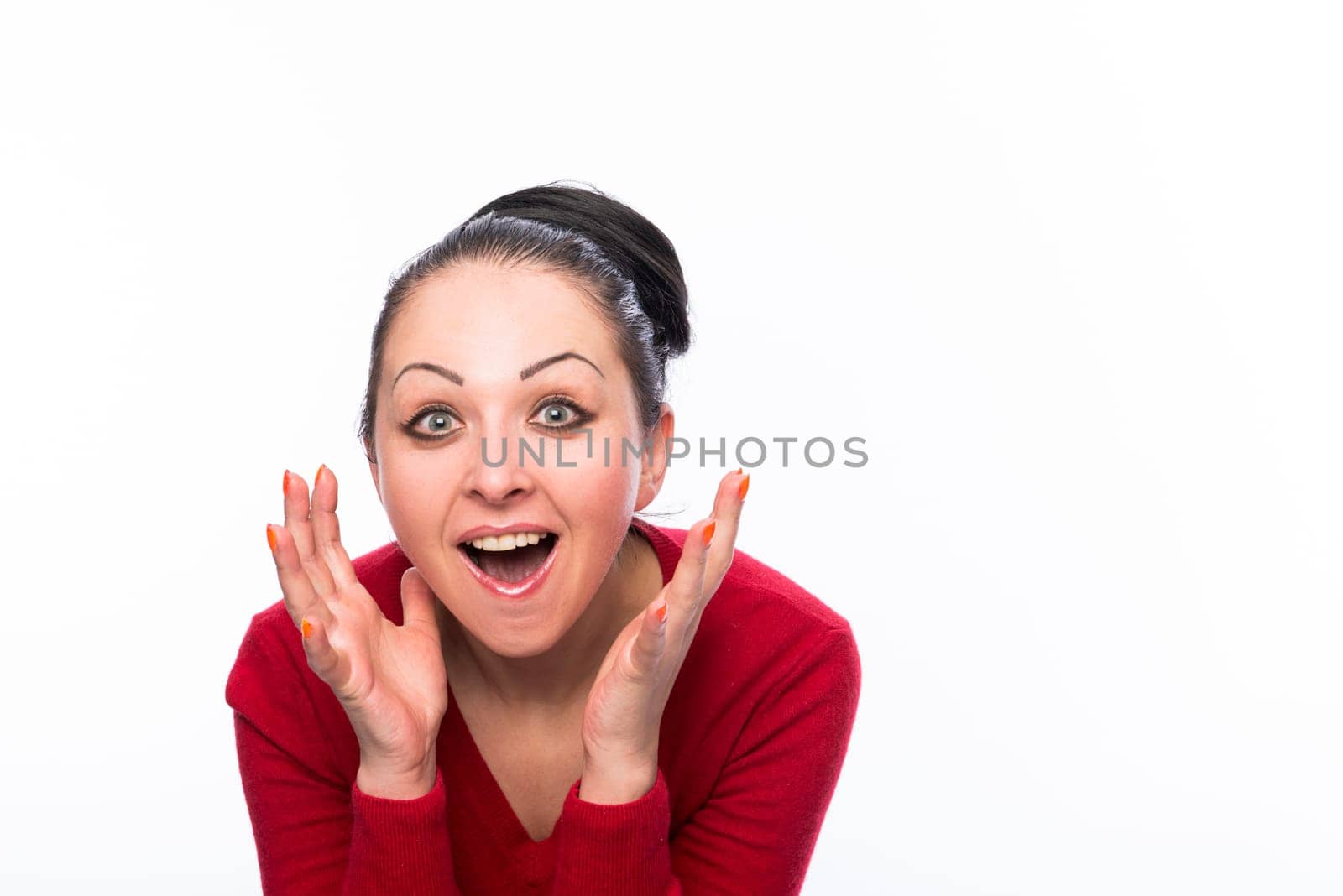 Portrait of beautiful caucasian woman wearing red dress and looking pleasantly surprised