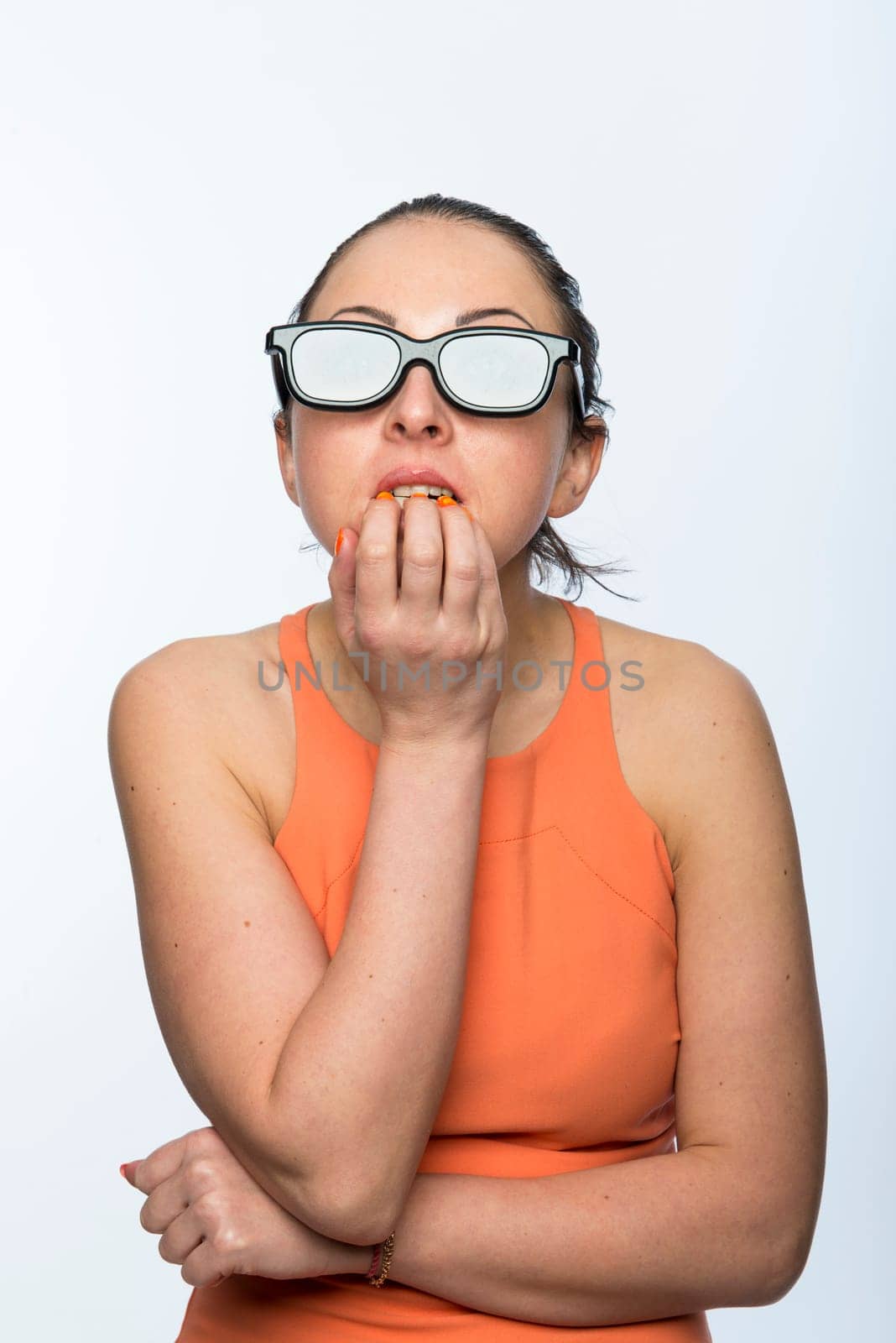 Portrait of beautiful caucasian woman wearing large 3D cinema glasses looking enthralled