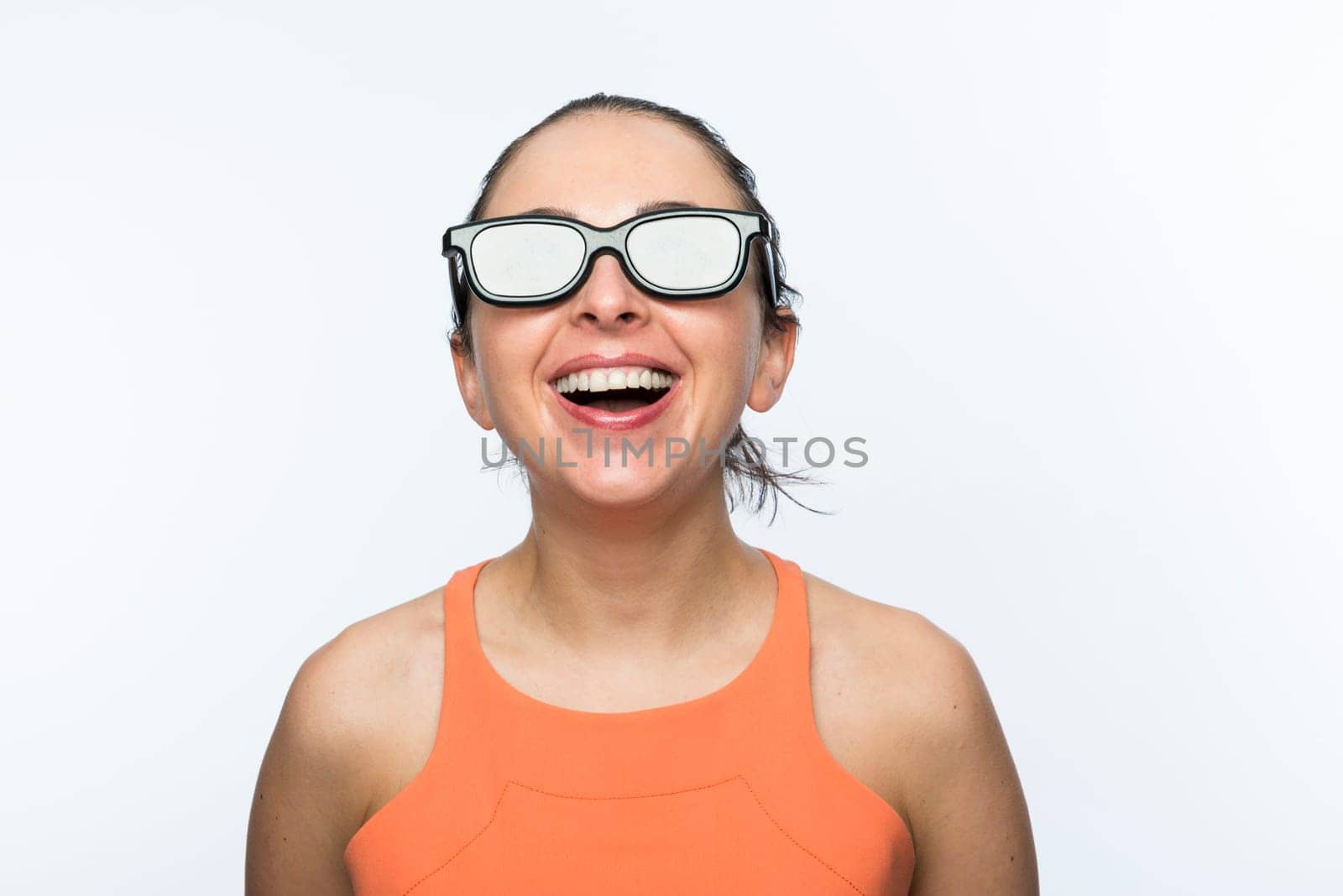 Portrait of beautiful caucasian woman wearing large 3D cinema glasses and smiling