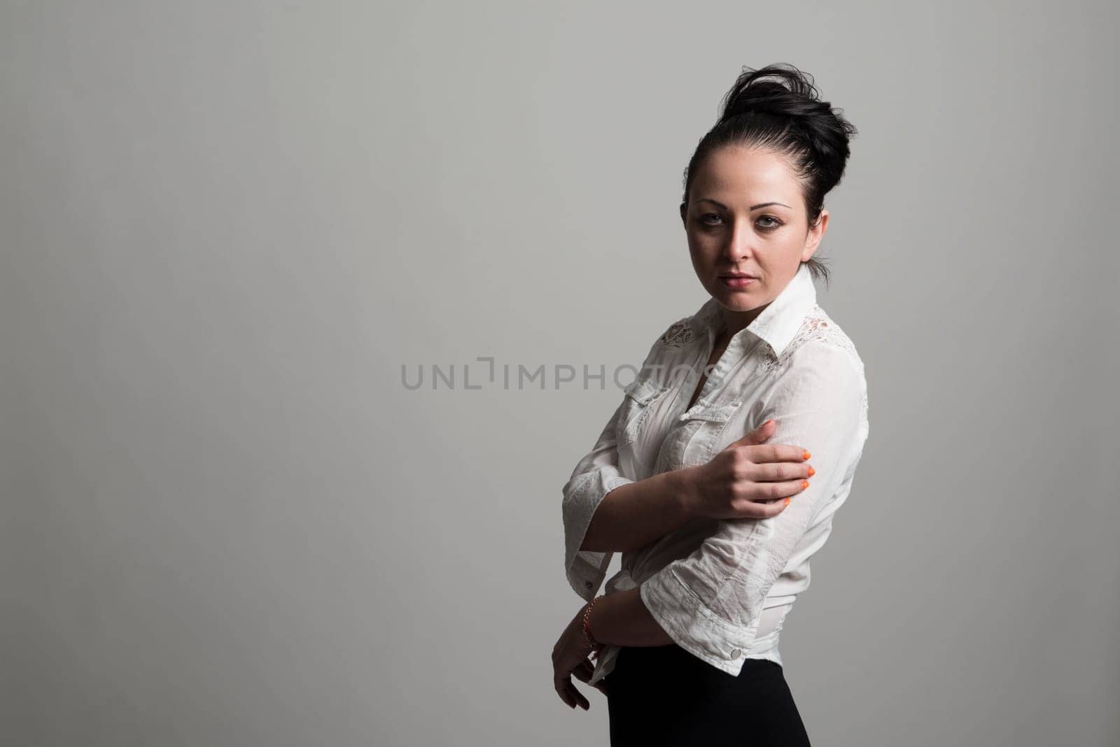 Fashion portrait of beautiful caucasian female model wearing white shirt