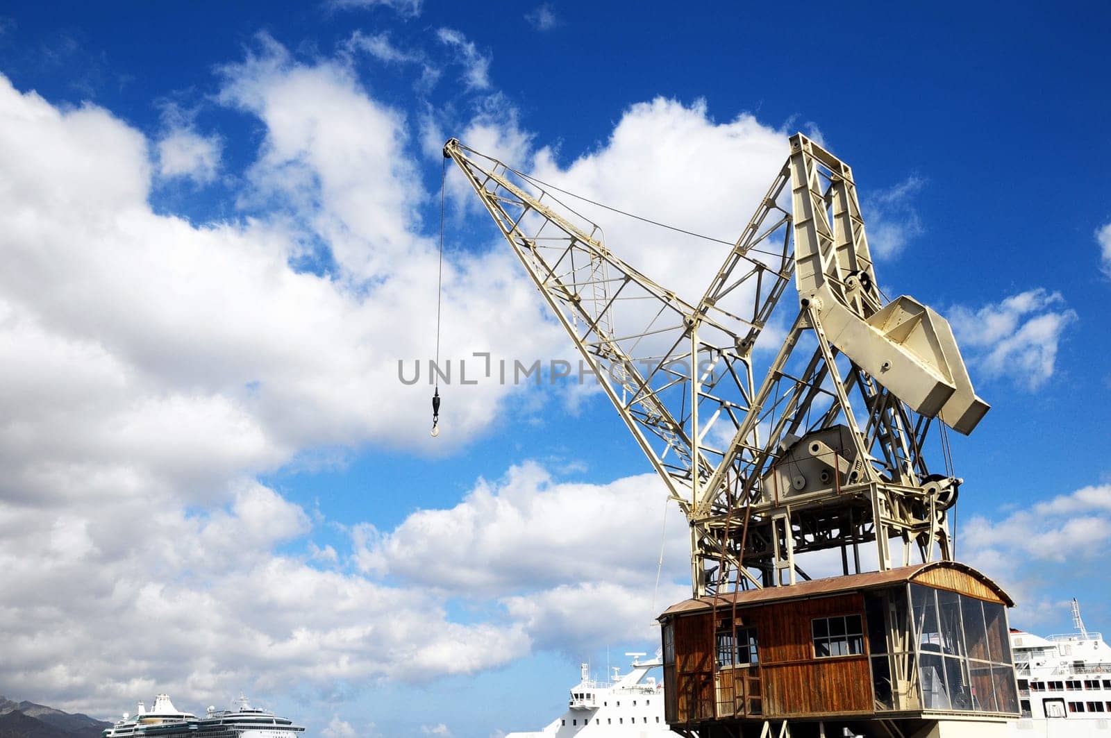 Old Vintage Wooden Port Crane on a Blue Sky