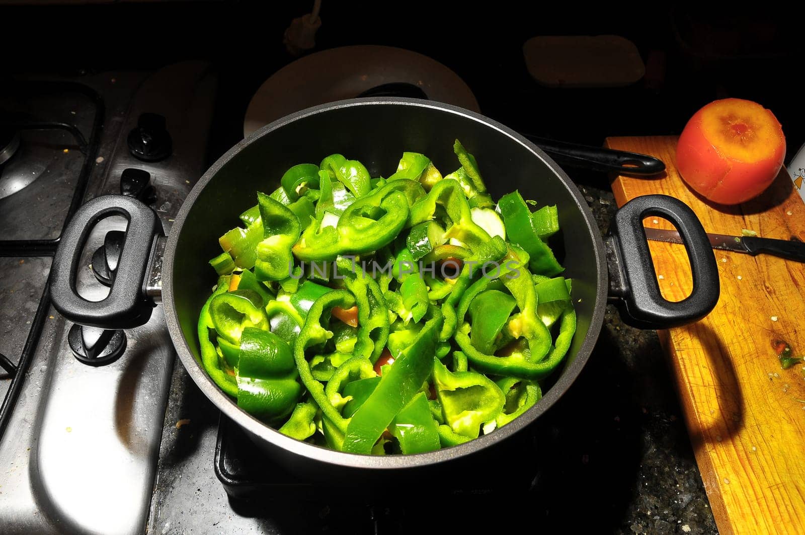Coocking Green Chili Pepperson a Black Pot