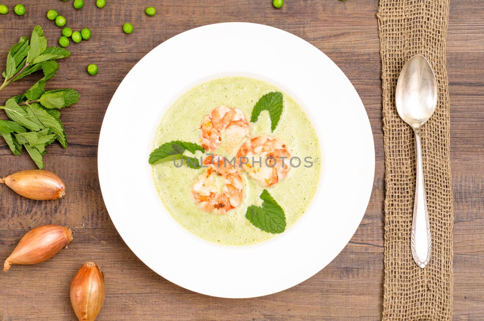 Shrimp in green soup from heritage on a white plate