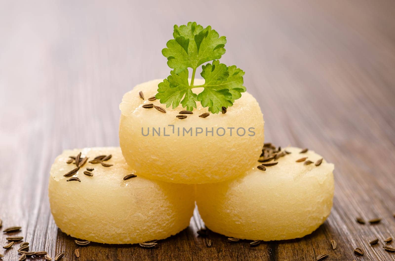 Harz cheese with parsley and cumin on a table