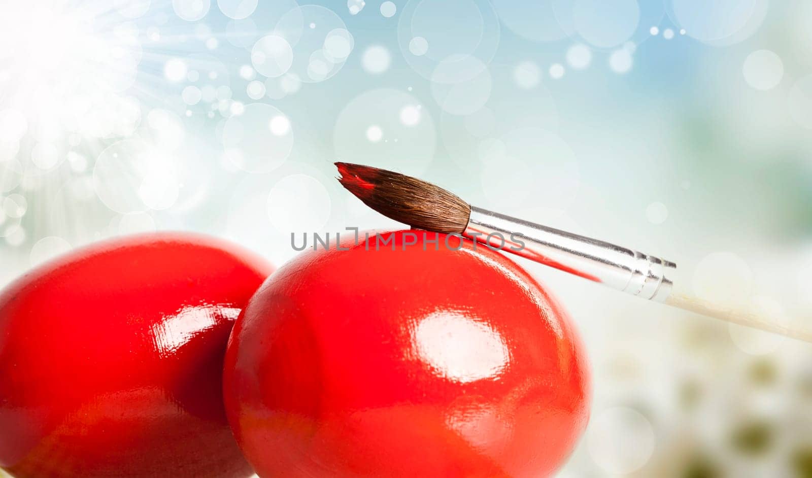 Easter eggs and paint brush on spring bokeh background